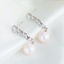 Show details for Famous Small White Dangle Earrings